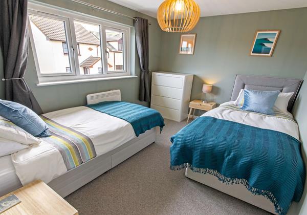 Spacious and calming twin bedroom