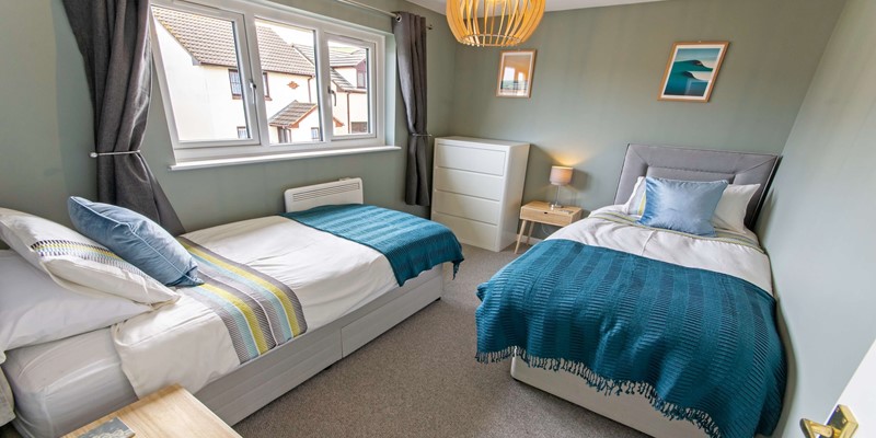 Spacious and calming twin bedroom