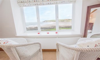 Master bedroom couple seating with the view of Croyde bay North Devon