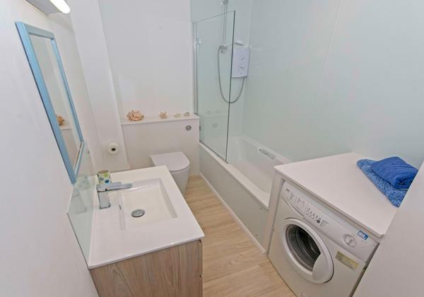 Family bathroom with bath, shower over, washbasin and w.c