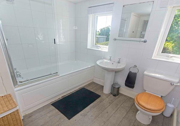 Family bathroom with bath, shower over, washbasin and w.c