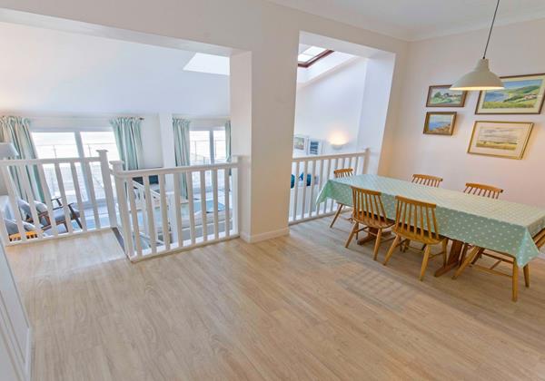 Light airy beach styled kitchen dining area