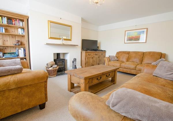TV lounge comfortable sofa's and fully stocked bookcase
