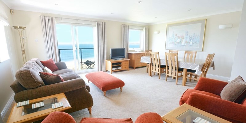 Lounge dining patio doors onto the balcony with sea views