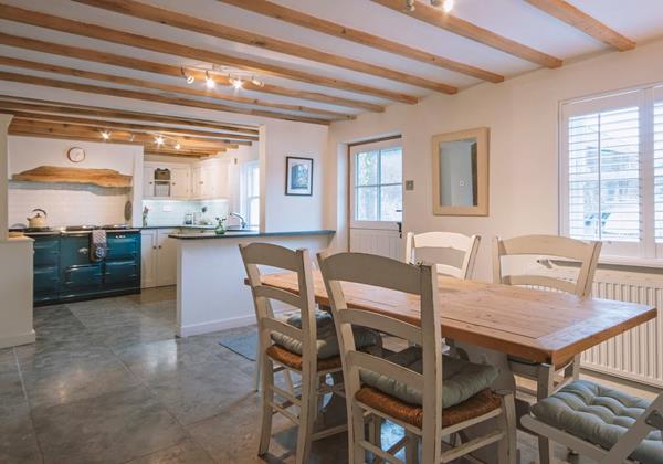 Open plan kitchen family dining with beamed ceiling